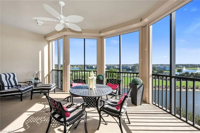 a living room with furniture and floor to ceiling windows