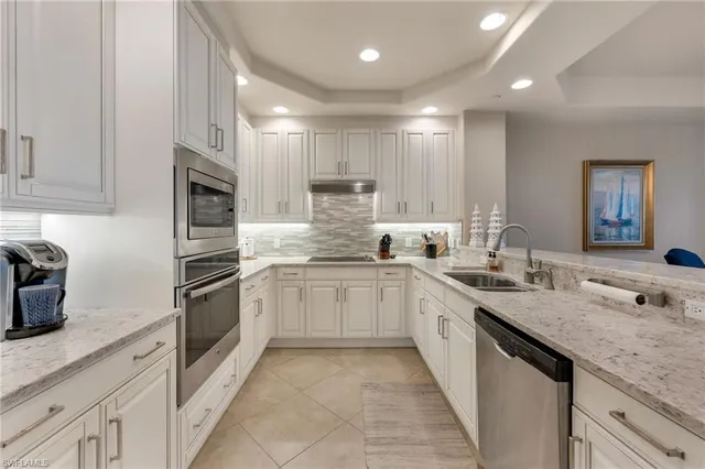 a kitchen with stainless steel appliances granite countertop a sink and stove top oven