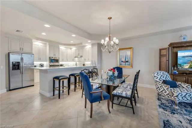 a view of a dining room with furniture and chandelier