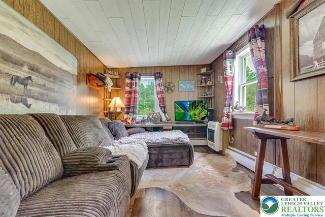 a bathroom with a sink a toilet a mirror and shower