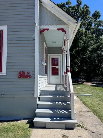 a kitchen with wooden floors and white cabinets
