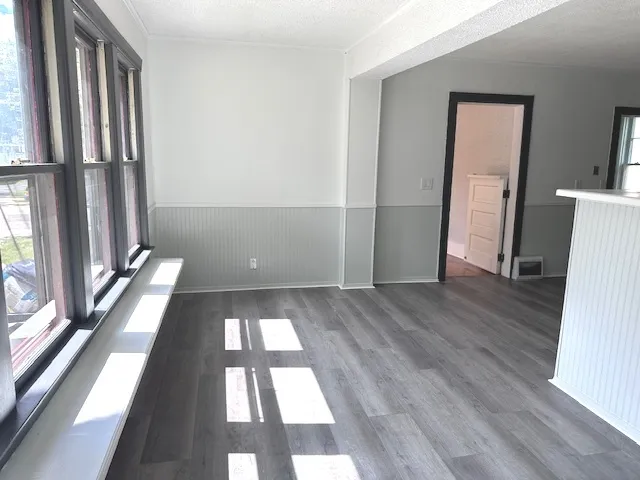 a dining room with furniture a chandelier and a window