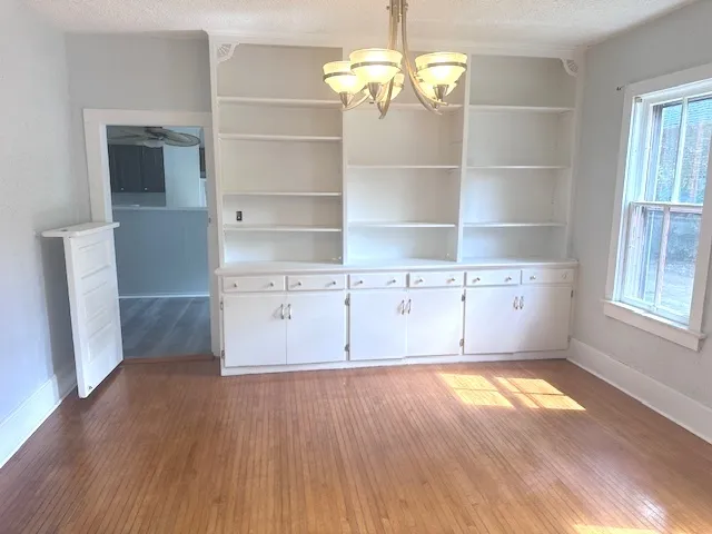 a view of a room with wooden floor and stairs