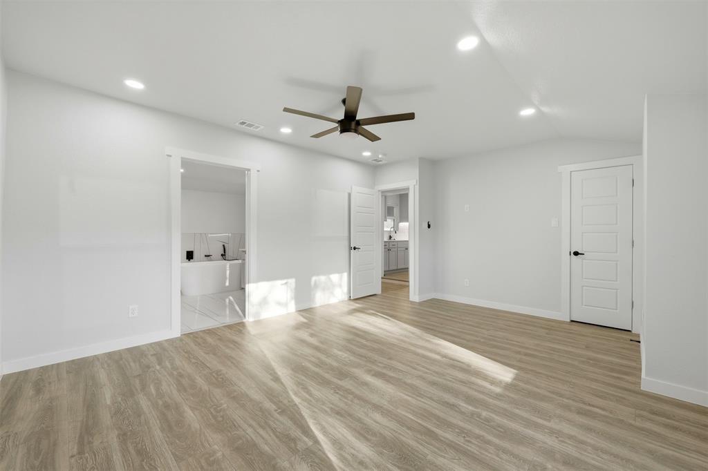 502 Madison Street Cleburne, TX 76033 - Photo 18 of 30 a view of empty room with wooden floor and ceiling fan
