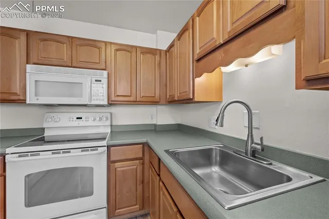 a kitchen with a sink cabinets and stainless steel appliances