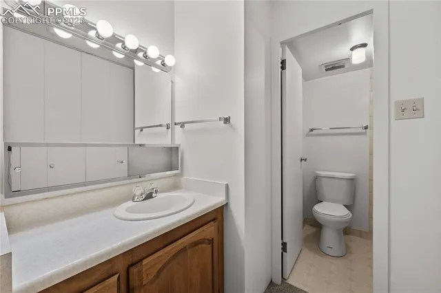 a bathroom with a sink toilet and a mirror