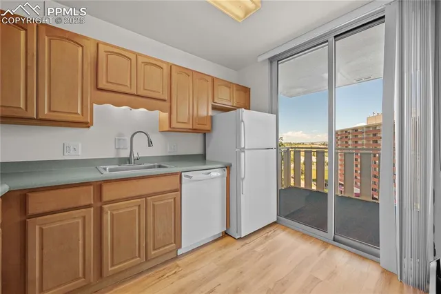 a kitchen with white cabinets and refrigerator