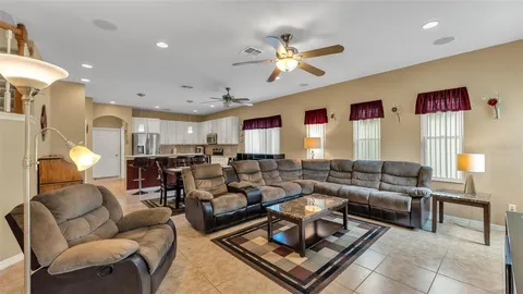 a bedroom with a bed and a flat tv screen on dresser