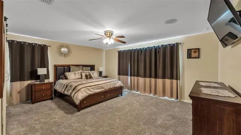 a bedroom with bed and a chandelier