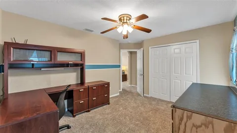 a living room with furniture and a glass door