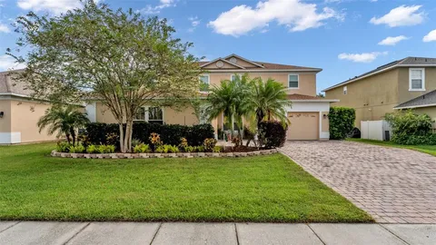 a front view of house with a garden