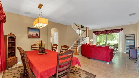 a living room with furniture a window and a chandelier