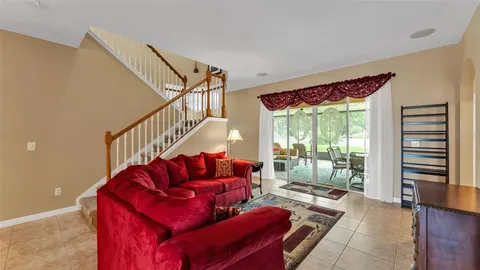 a living room with furniture cabinets and wooden floor
