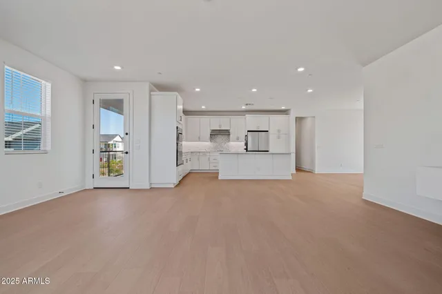 a kitchen with stainless steel appliances kitchen island granite countertop a stove a sink and a refrigerator