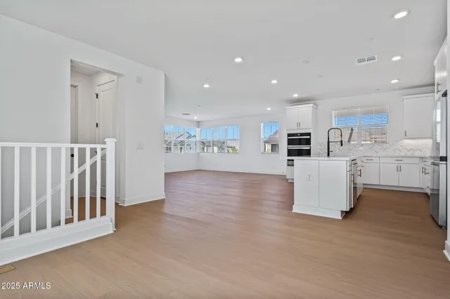 a view of a room with wooden floor