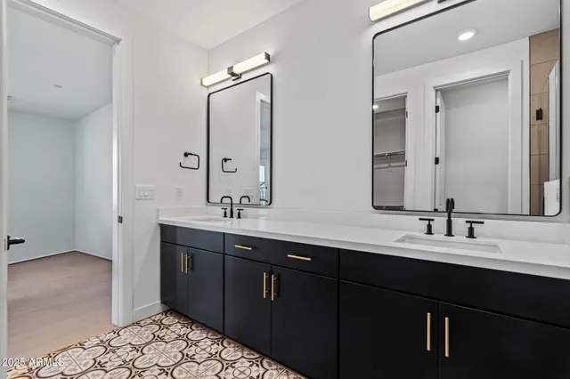 a bathroom with a sink a toilet a mirror and shower