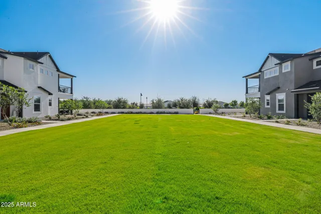 a living room with couches a fireplace and a large window with garden view