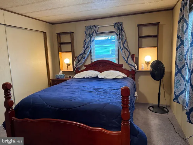 a bedroom with a bed and two mirror