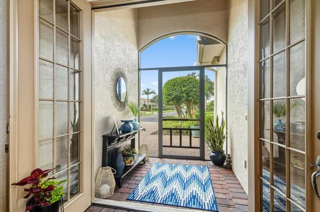 a view of an entryway with wooden floor and a livingroom view