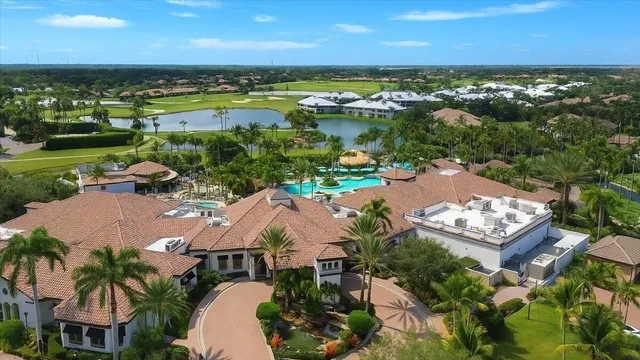 an aerial view of residential houses with outdoor space and ocean view