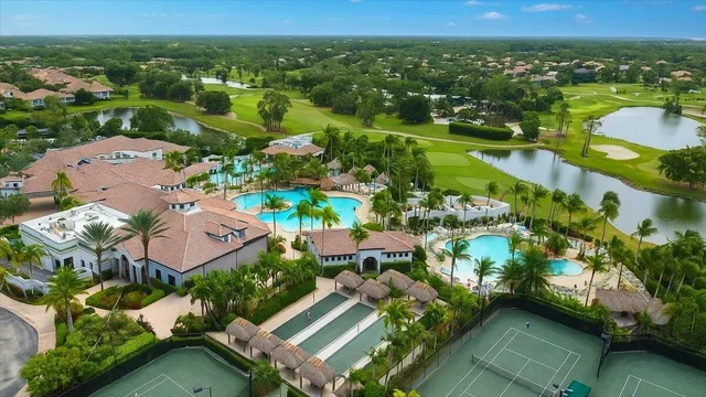 an aerial view of a city with lots of residential buildings ocean and mountain view in back