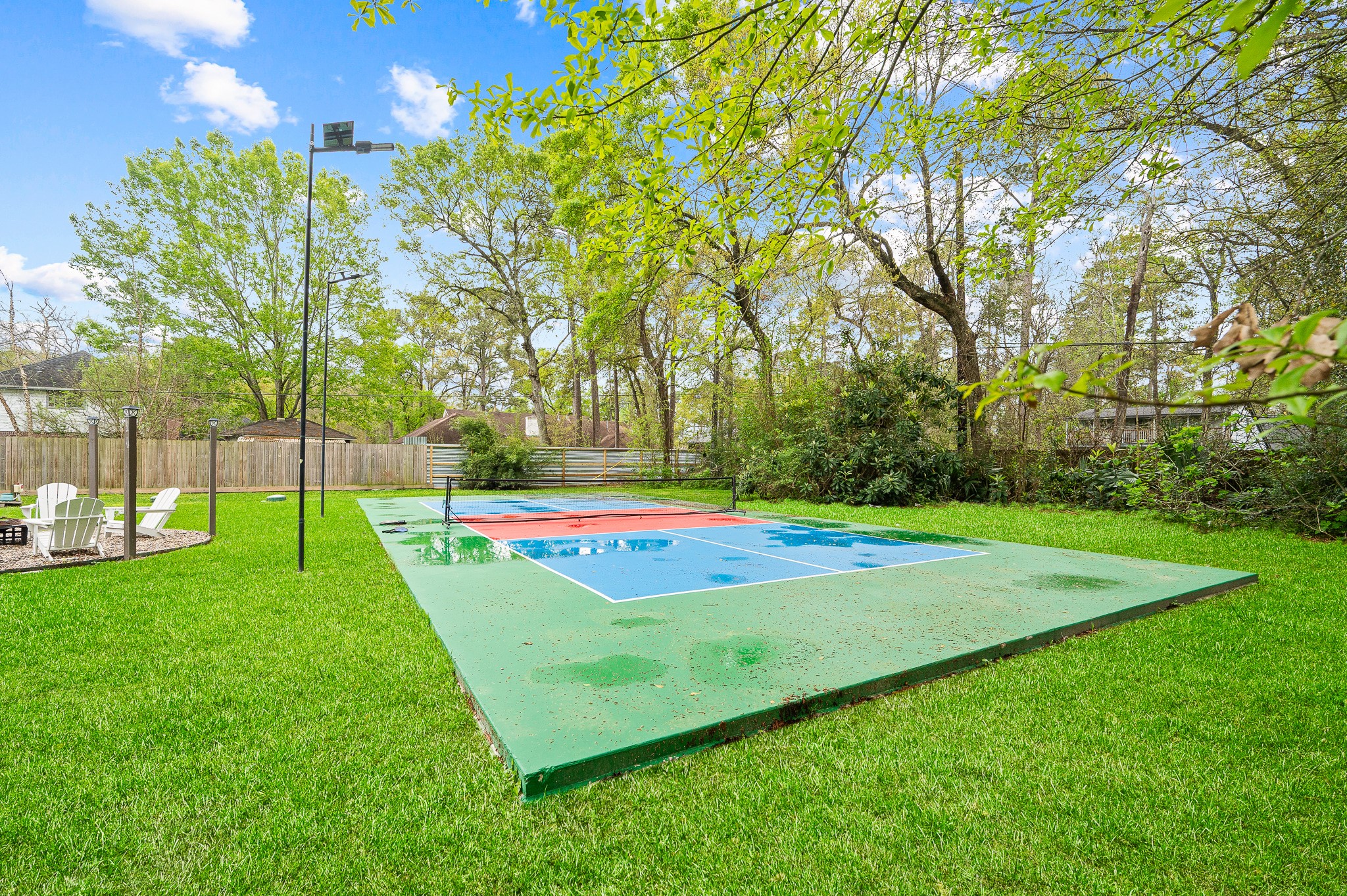 16811 Waycreek Road Houston, TX 77068 - Photo 16 of 50 a view of a tennis ground with large trees
