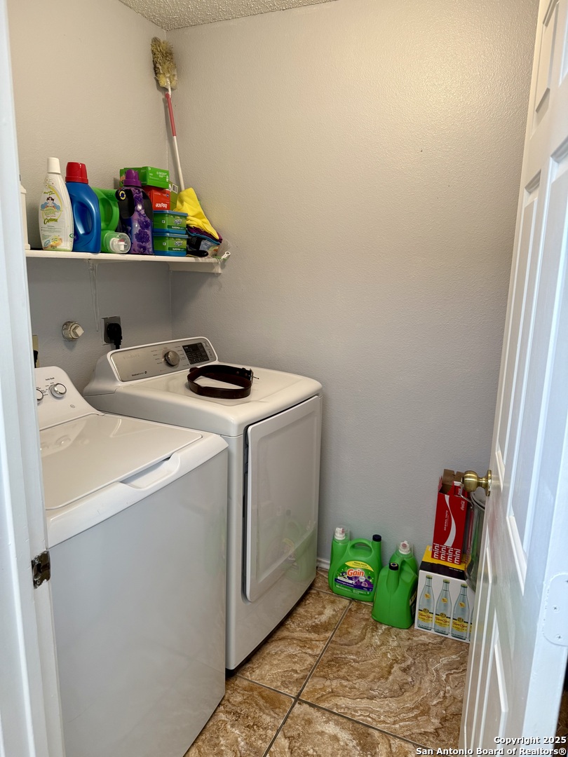 6719 Raintree Path San Antonio, TX 78233 - Photo 14 of 24 a utility room with dryer and washer