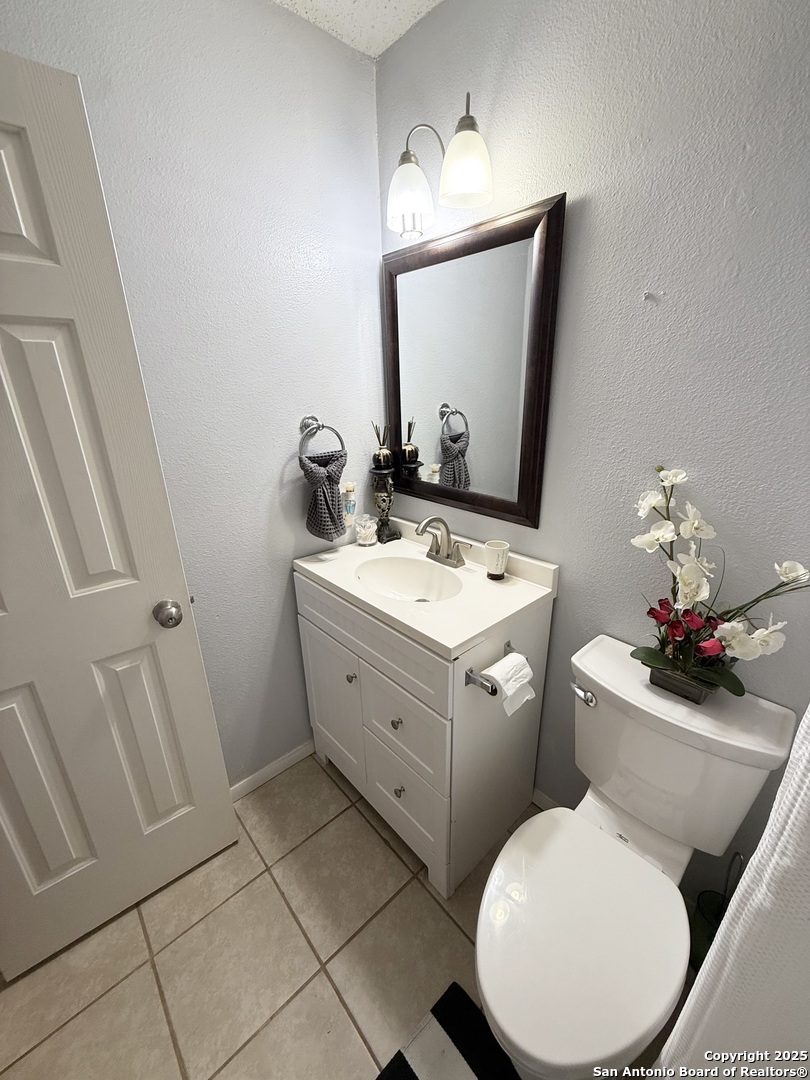 6719 Raintree Path San Antonio, TX 78233 - Photo 17 of 24 a bathroom with a toilet sink and mirror