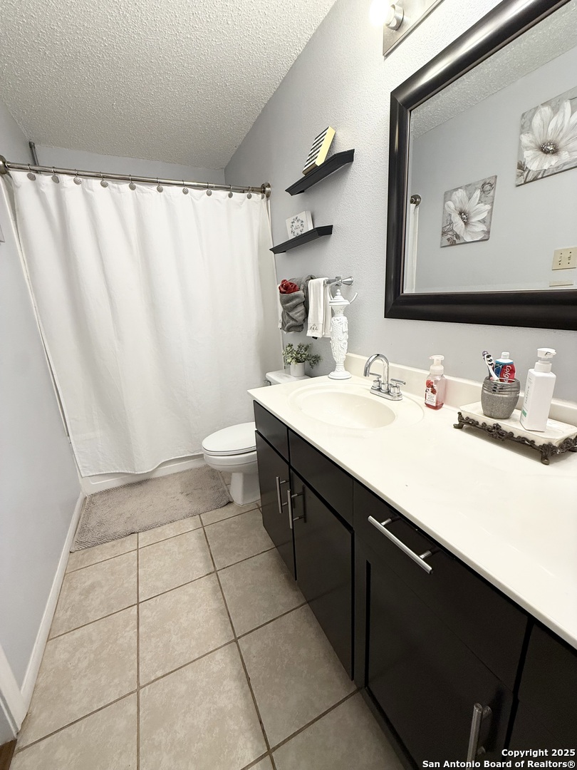 6719 Raintree Path San Antonio, TX 78233 - Photo 19 of 24 a bathroom with a sink a toilet and a mirror