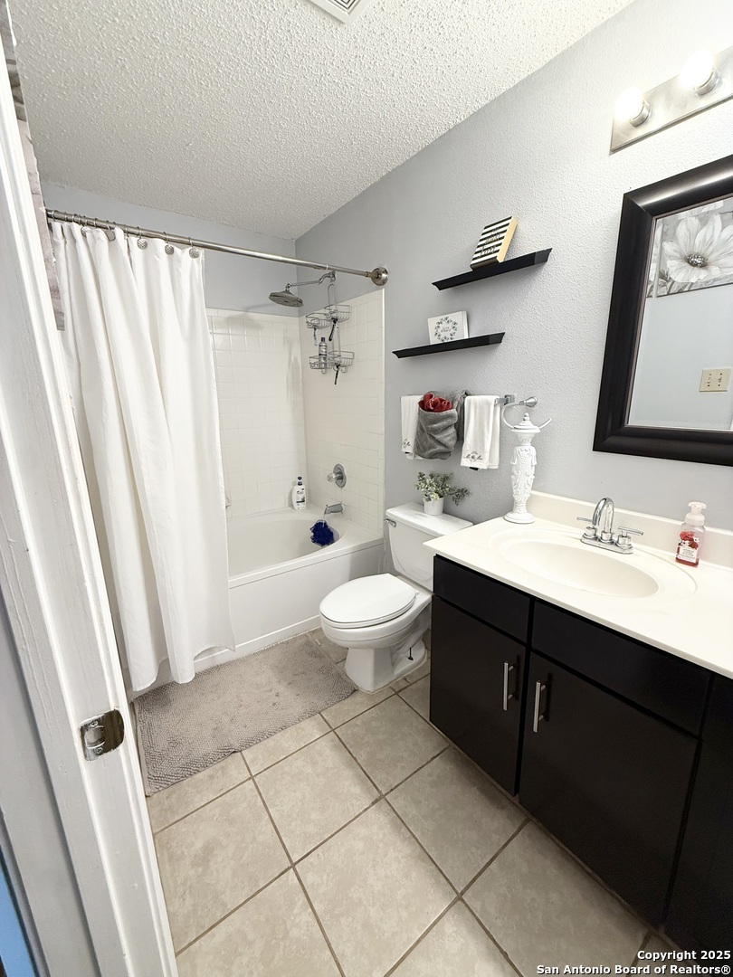 6719 Raintree Path San Antonio, TX 78233 - Photo 20 of 24 a spacious bathroom with a double vanity sink toilet and shower