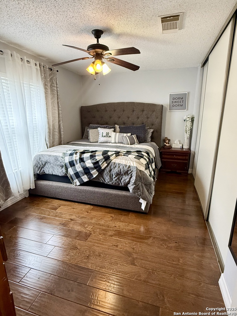 6719 Raintree Path San Antonio, TX 78233 - Photo 3 of 24 a bedroom with a bed and a chandelier