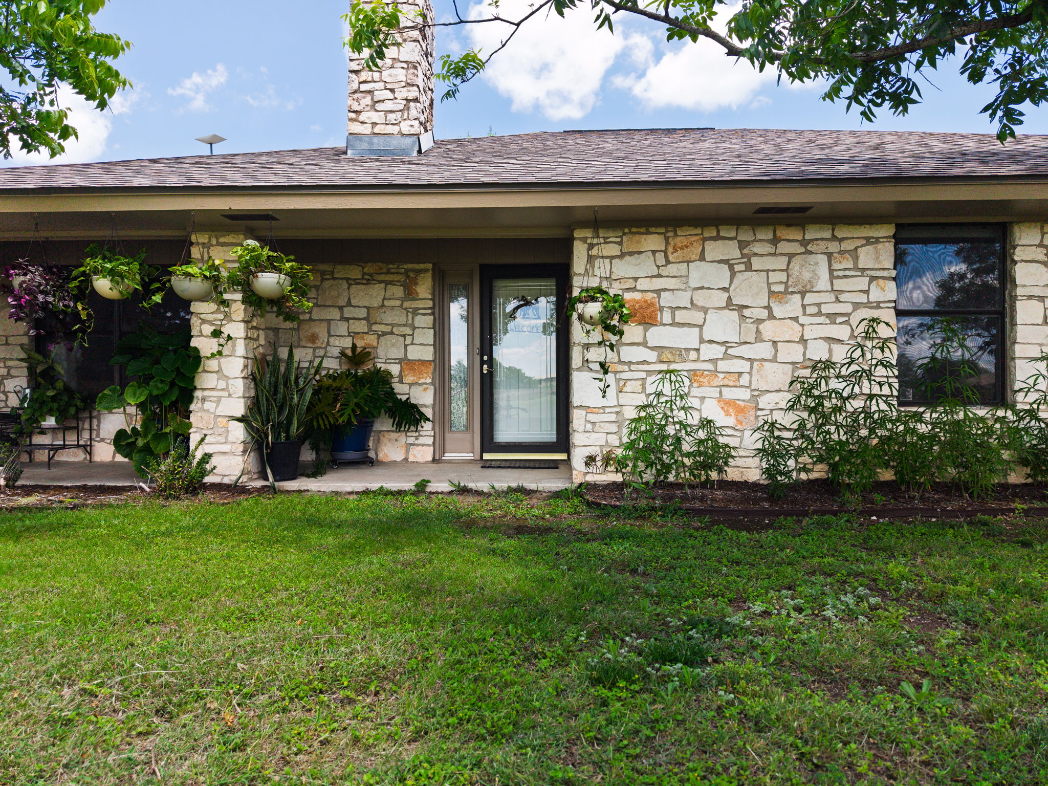 120 Rae Lane Jarrell, TX 76537 - Photo 1 of 40 Exterior showcasing a stone facade, a brown shingle roof, and a stone chimney