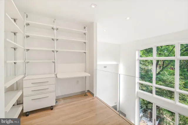 a view of an empty room with cabinet and entryway