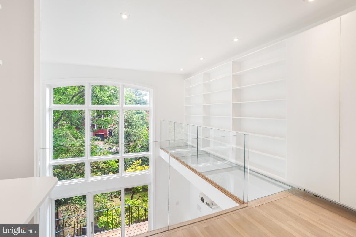 3927 Georgetown Court Northwest Washington, DC 20007 - Photo 18 of 36 Floating glass cat walk and bookshelves