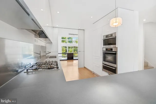a kitchen with a stove a sink and a microwave