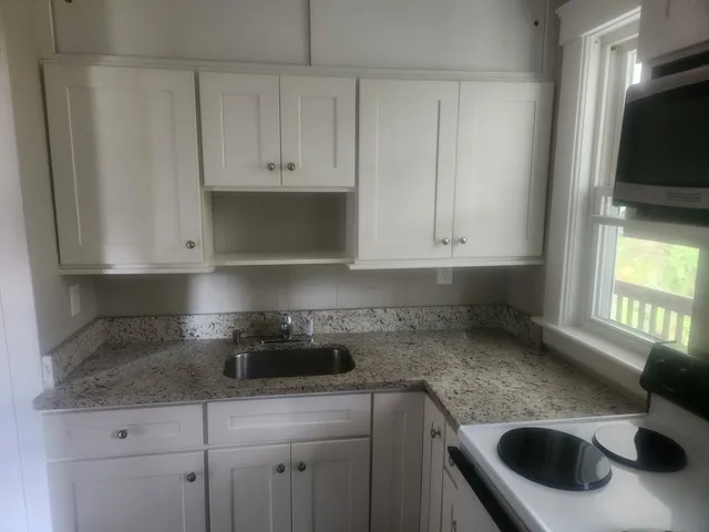 a kitchen with a sink and cabinets