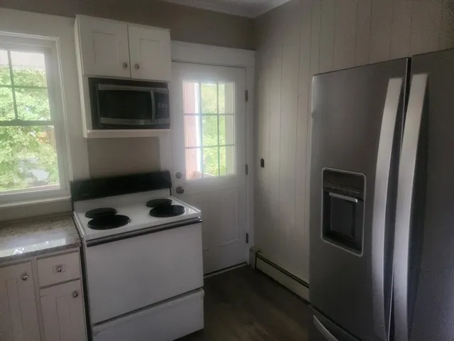 a kitchen with a refrigerator stove and microwave