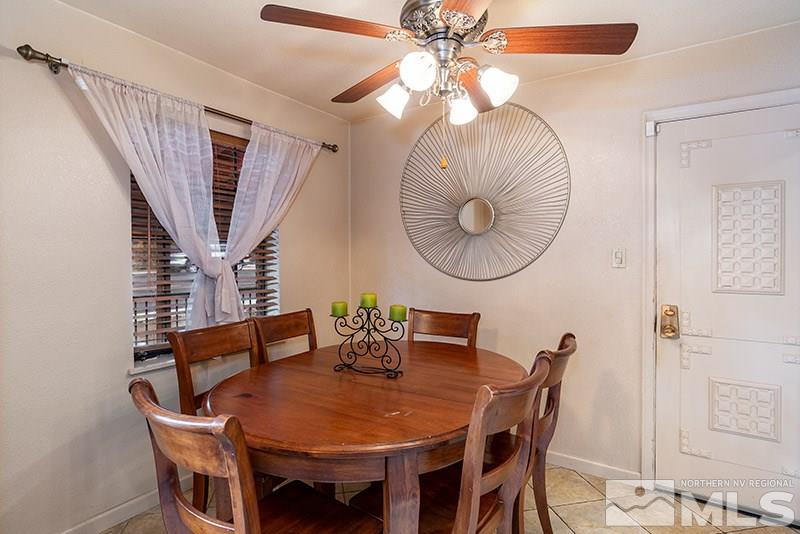 844 Whitaker Drive Reno, NV 89503 - Photo 20 of 34 a dining room with furniture a chandelier and a mirror