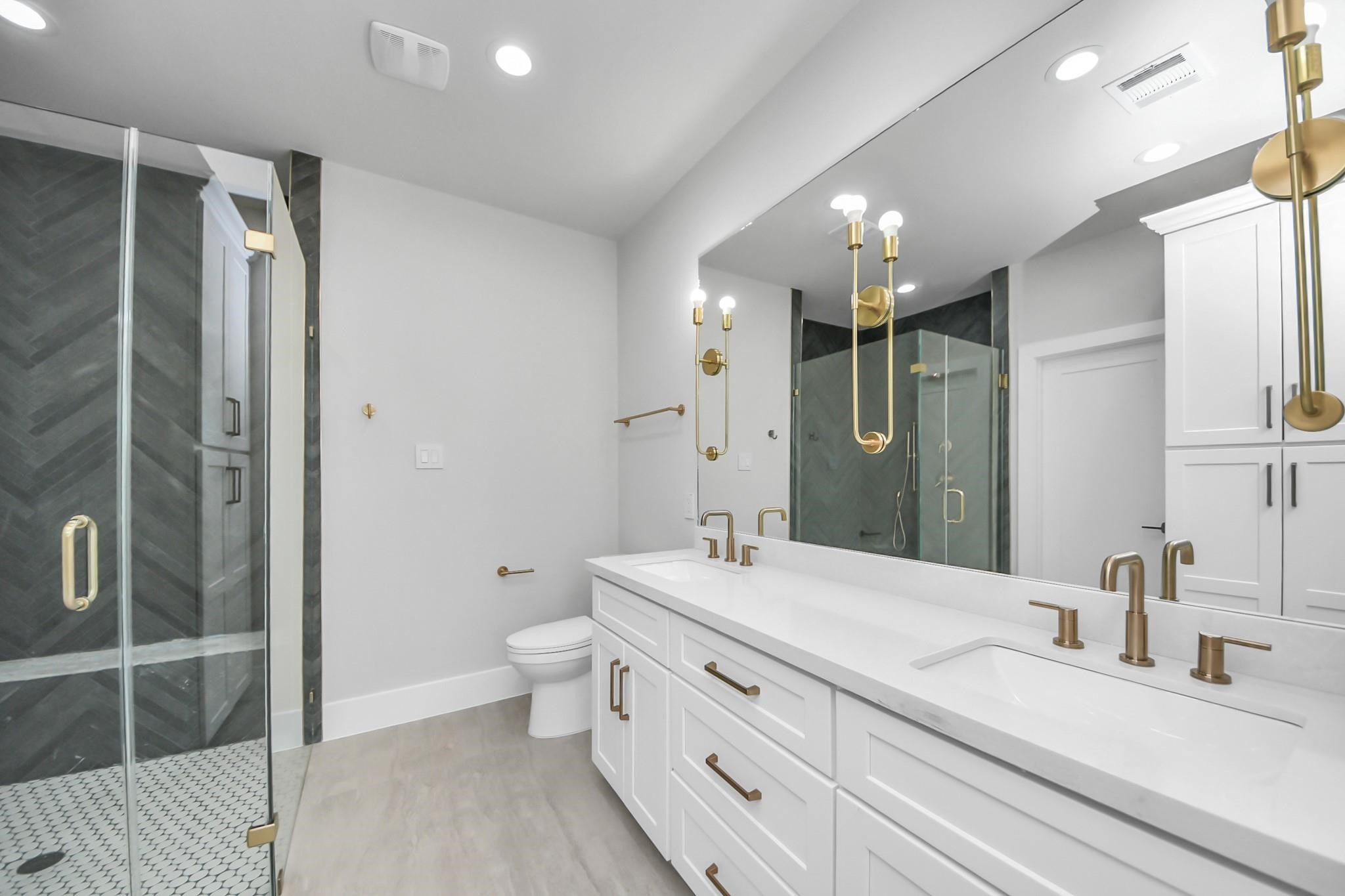 6320 Milwee Street, Unit B Houston, TX 77092 - Photo 20 of 30 a bathroom with a double vanity sink mirror and toilet