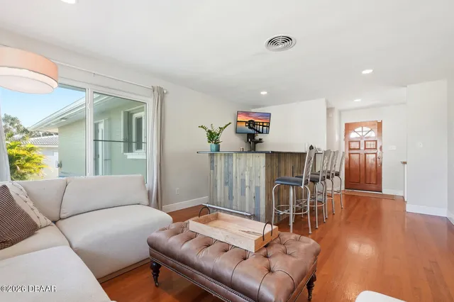 a living room with furniture and a wooden floor