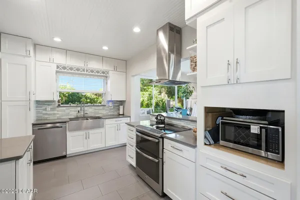a kitchen with stainless steel appliances a stove sink and cabinets