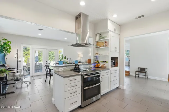 a kitchen with stainless steel appliances a stove a sink and a refrigerator