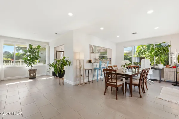 a view of a dining room with furniture and a potted plant