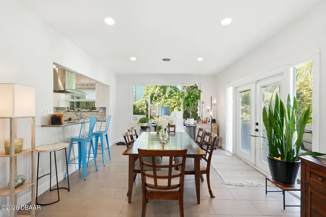 a dining room with furniture window and wooden floor