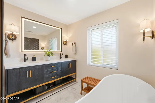 a spacious bathroom with a double vanity sink and a mirror
