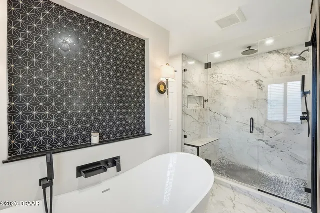 a bathroom with a bathtub and shower