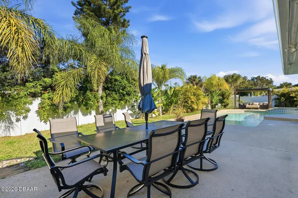 a view of a chairs and table in patio
