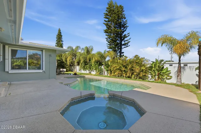 a view of a swimming pool with an outdoor seating
