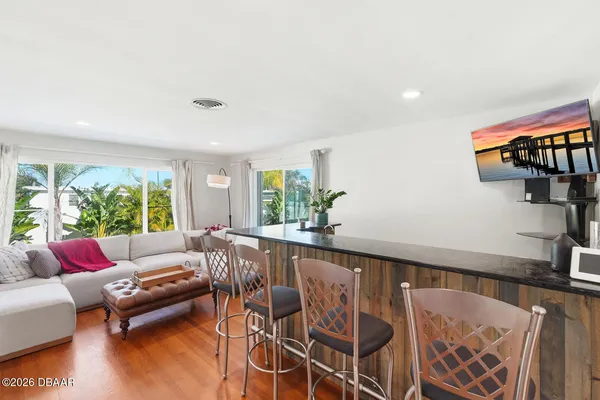 a living room with furniture and floor to ceiling window