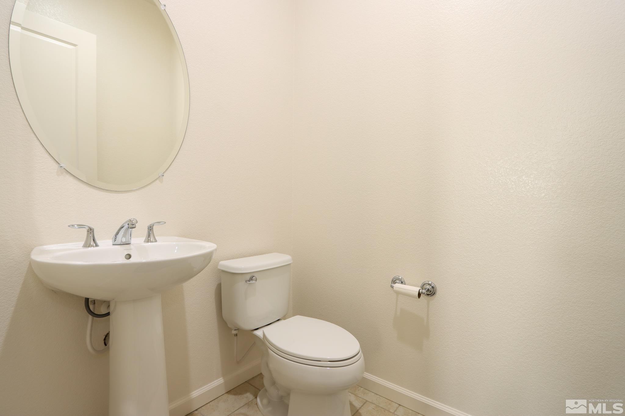 9410 Stony Hill Road Reno, NV 89521 - Photo 12 of 39 a bathroom with a sink a toilet and a mirror